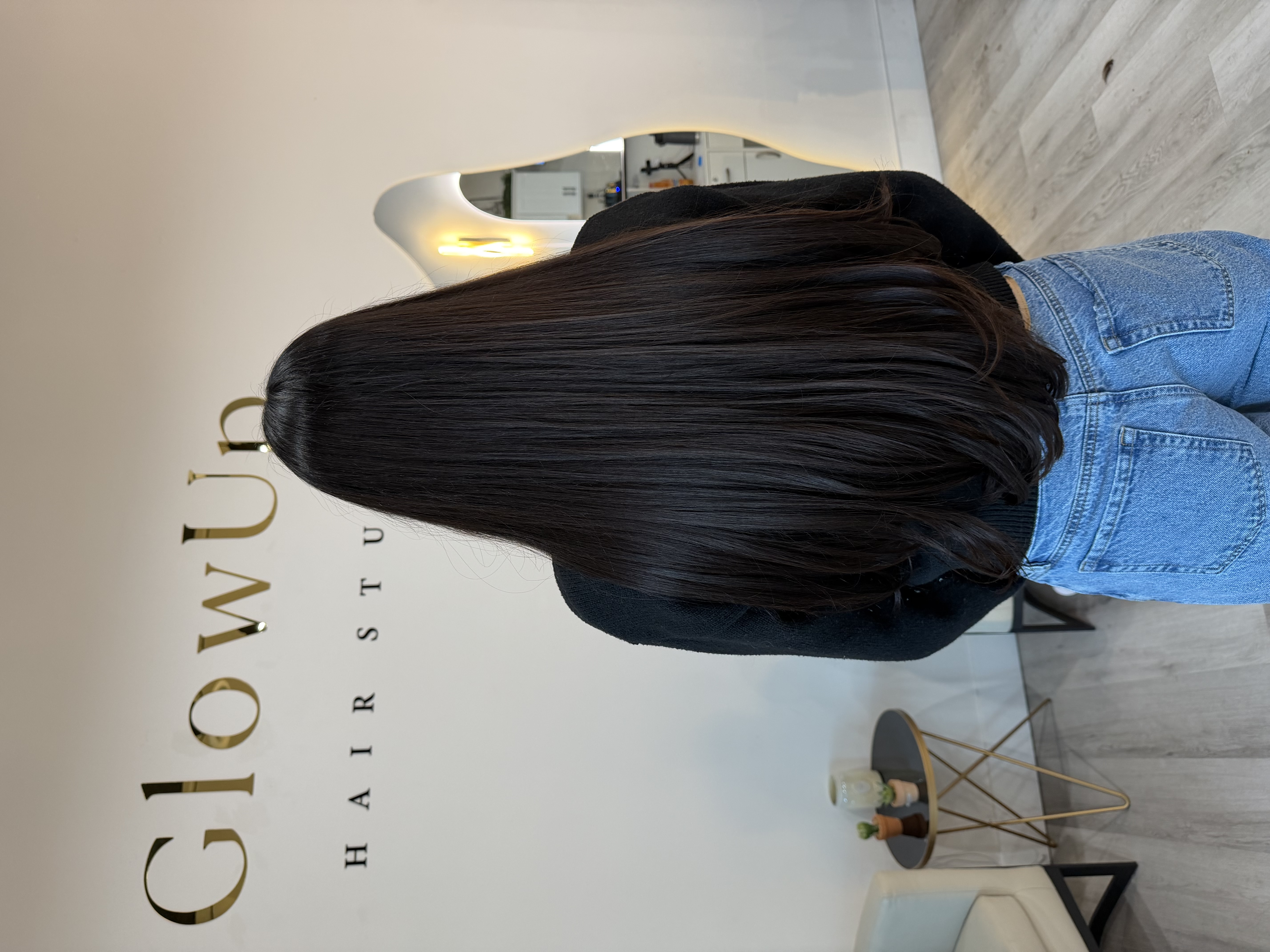 Sleek dark hair finish at Glow Up Hair Studio